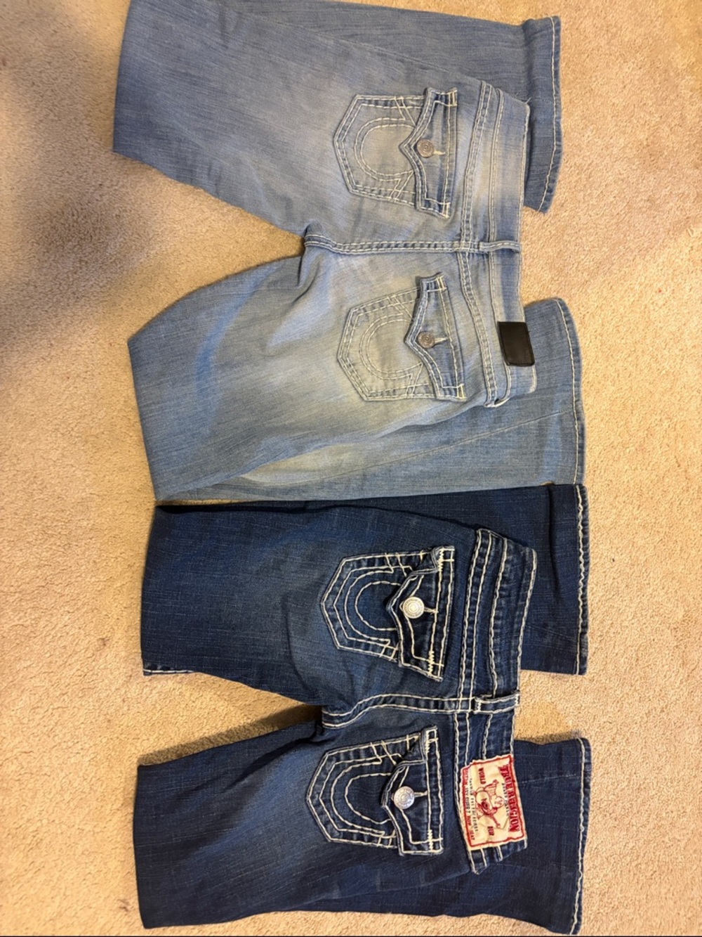 Bundle of two ultra low rise True Religion jeans in light and dark blue